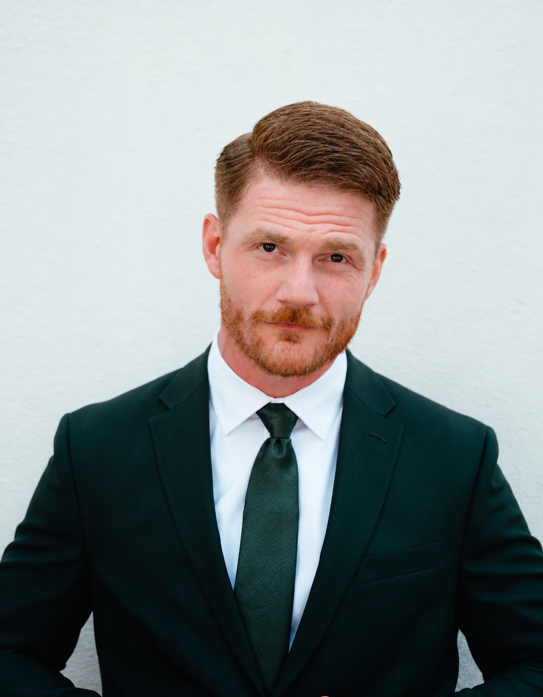 Bobby Saunders in a dark suit and tie